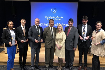 (L to R) Beverly Chang, Jason Starr, Michael Palumbo, MD, County Executive George Latimer, Commissioner of Health Dr. Sherlita Amler, Board of Health President Robert Baker MD, Jesse Montero and Judy Troilo